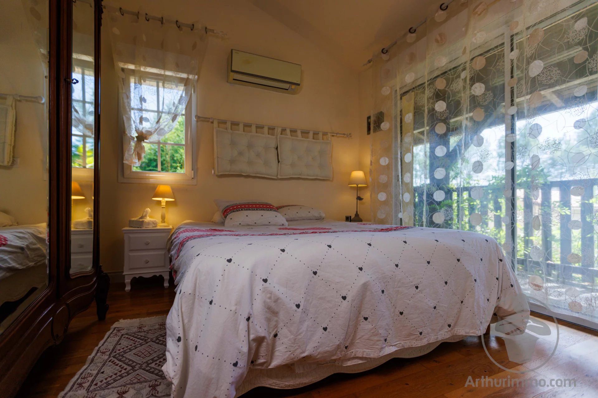 Welcoming bed and breakfast Guest room with double bed and warm decor, windows letting in light.
