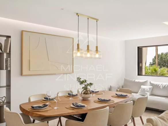 Interior of a modern apartment with a bright dining room and living room.