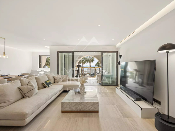 Interior of a luxury apartment in Cannes with sea view, modern and bright living room.