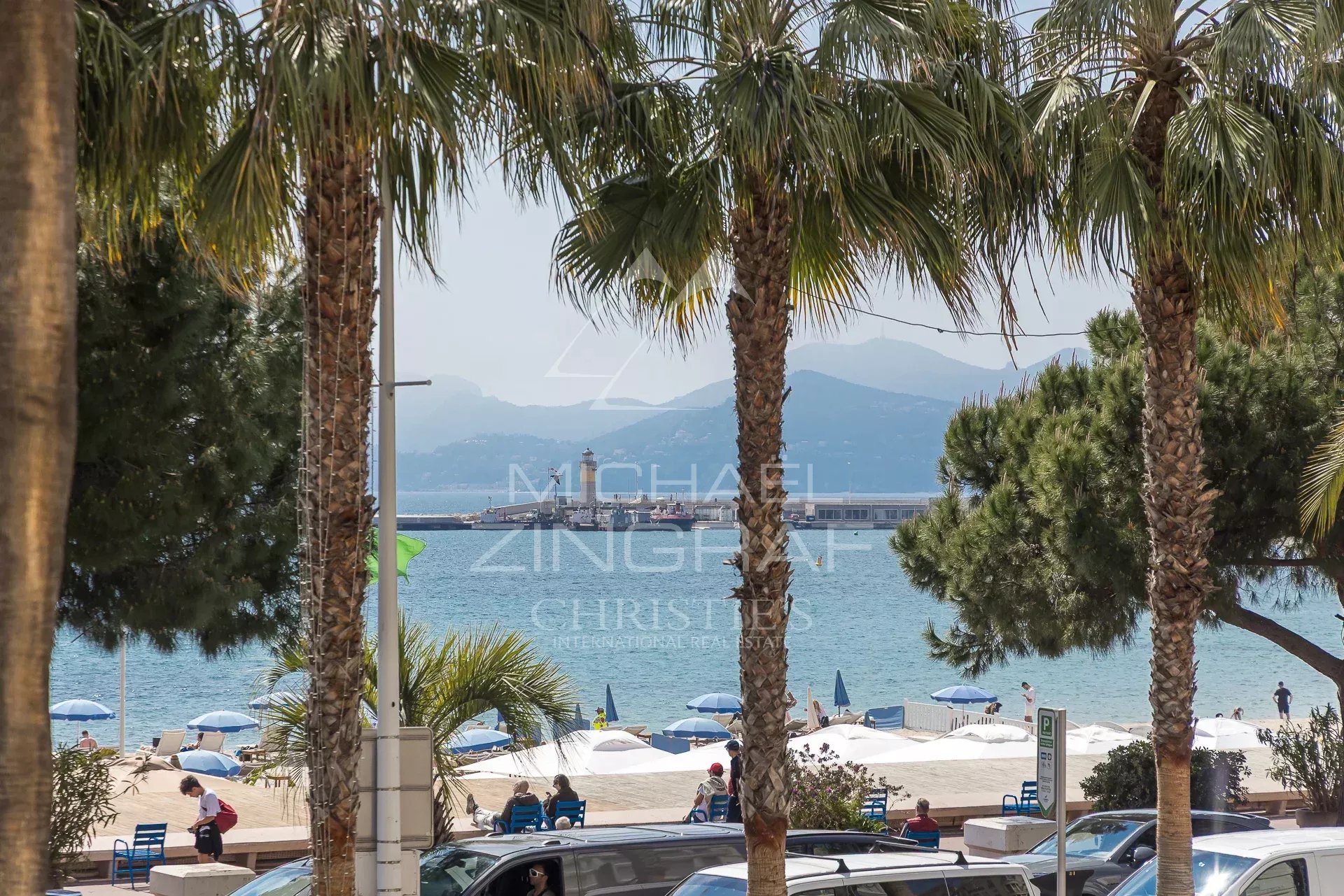 Apartment with sea view in Cannes Sea view from an apartment on the Croisette in Cannes, with palm trees in the foreground.