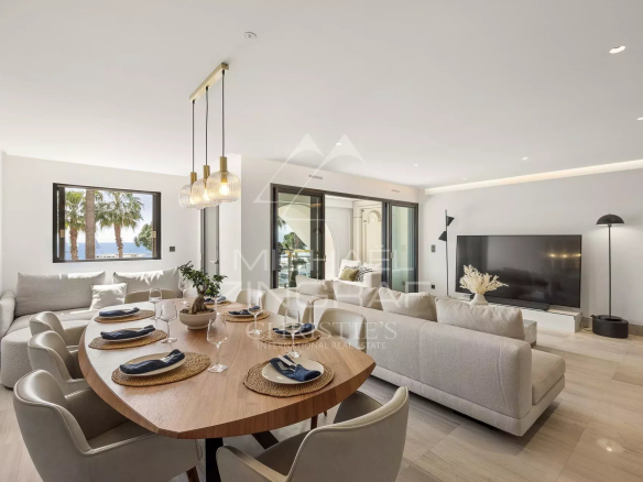 Interior of a luxury apartment in Cannes with sea view, modern living room and dining room.