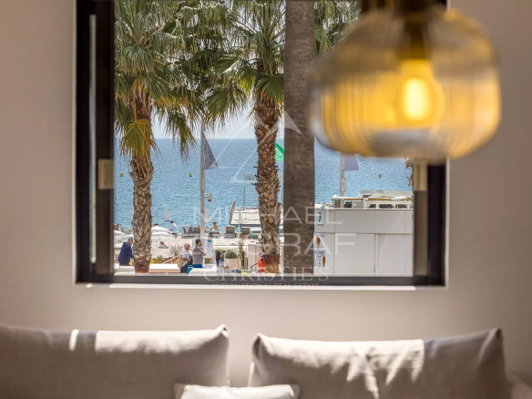 View from an apartment on the Croisette in Cannes, with sea and palm trees in the background.