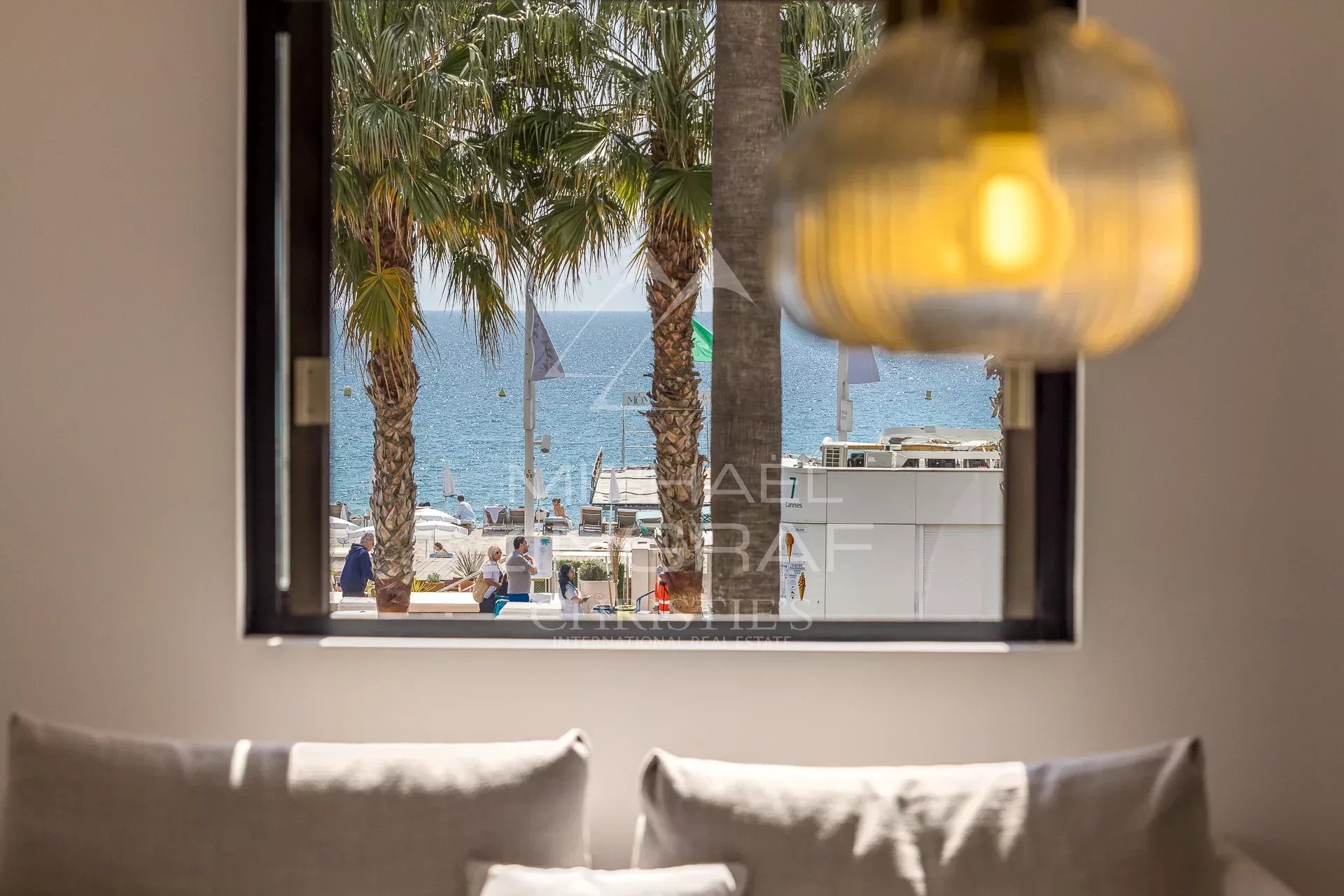 Apartment with sea view in Cannes View from an apartment on the Croisette in Cannes, with sea and palm trees in the background.