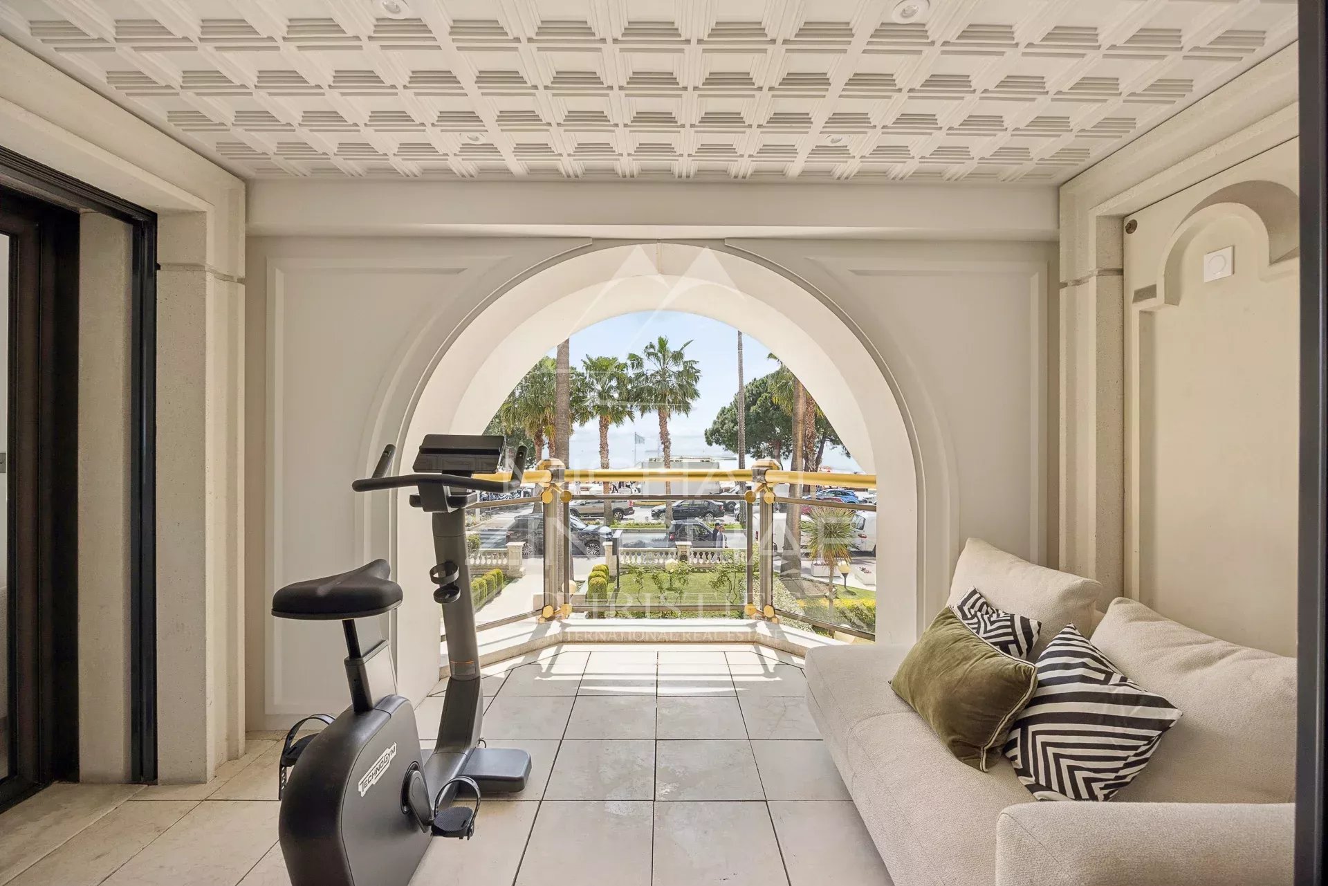 Luxury apartment in Cannes Interior of an apartment in Cannes with sea view, including a living area and an exercise bike.