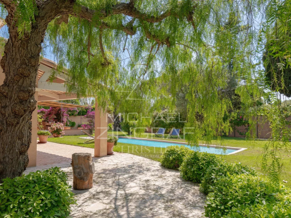 View of a garden with swimming pool and tree in Cap d'Antibes.