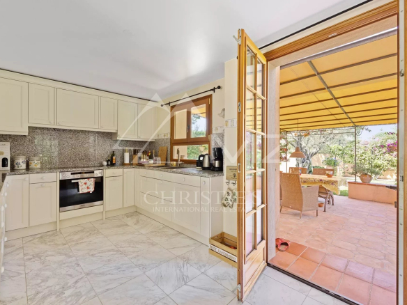 Bright kitchen of the villa in Cap d'Antibes with access to an outdoor terrace.