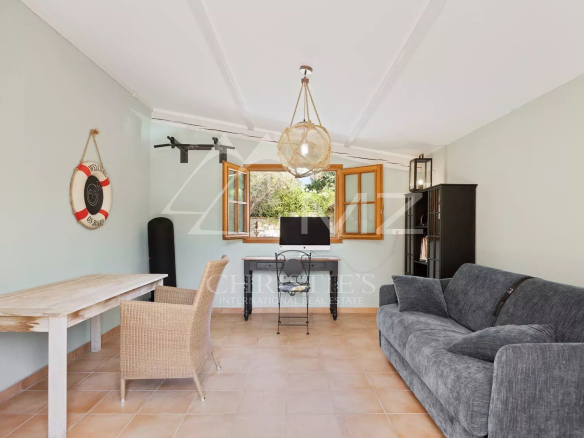 Interior of a villa in Cap d'Antibes with a bright living room and open windows.