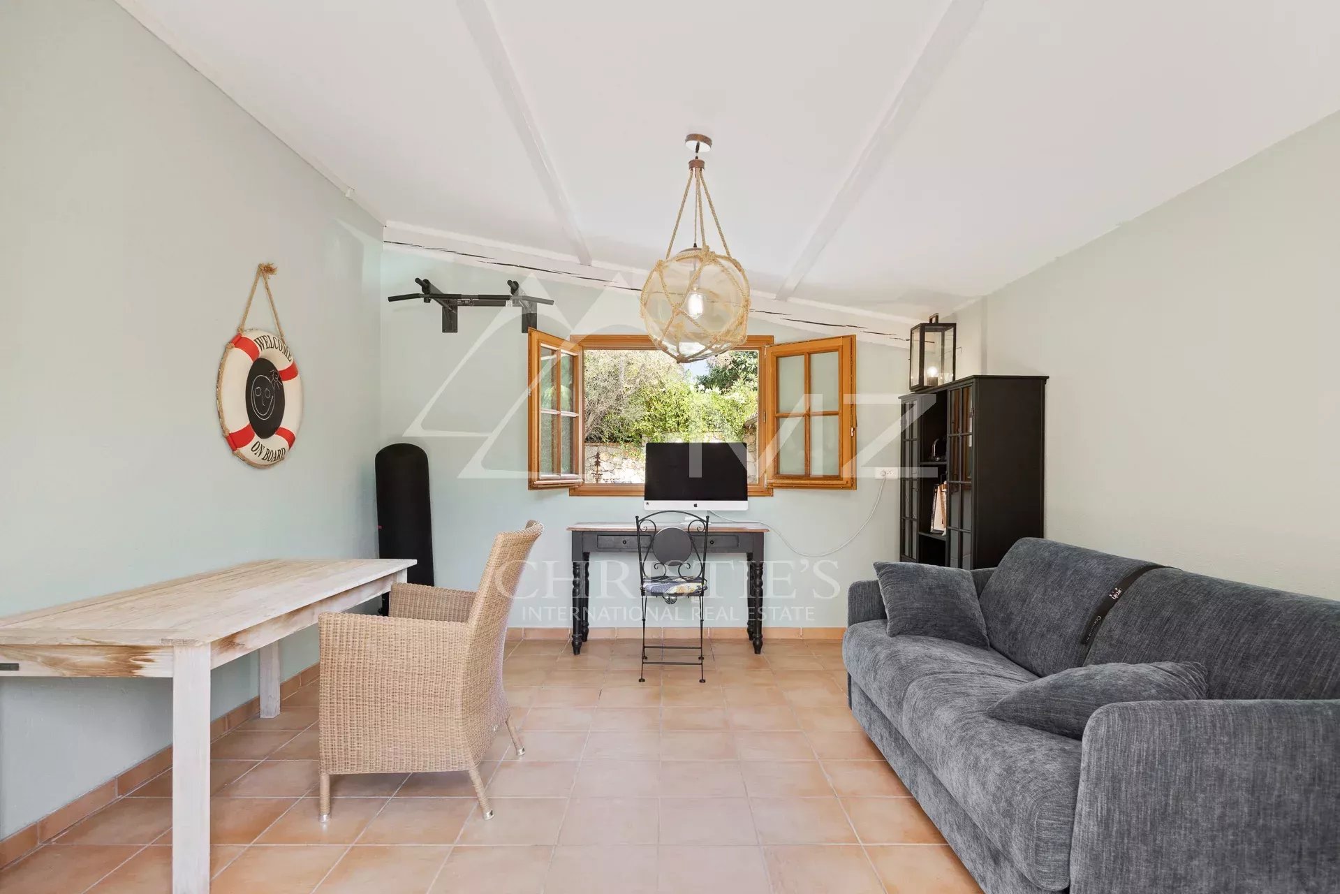 Interior of a villa in Cap d'Antibes Interior of a villa in Cap d'Antibes with a bright living room and open windows.
