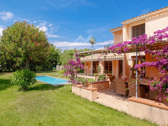 Villa with garden and swimming pool in Cap d'Antibes, surrounded by flowers and trees.