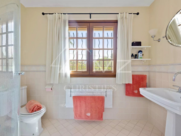Bright bathroom with shower, sink and windows on the upper floor of a villa in Cap d'Antibes.