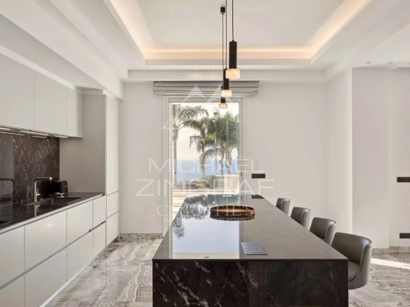 Modern kitchen with central island in a bright apartment in Cannes.