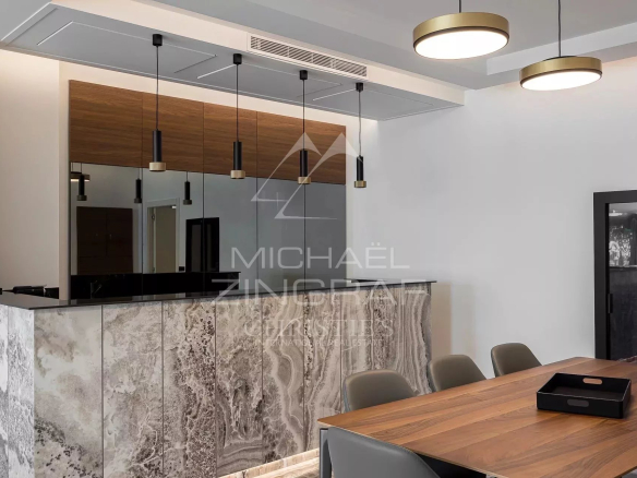 Interior of a renovated apartment with open-plan kitchen and dining room.