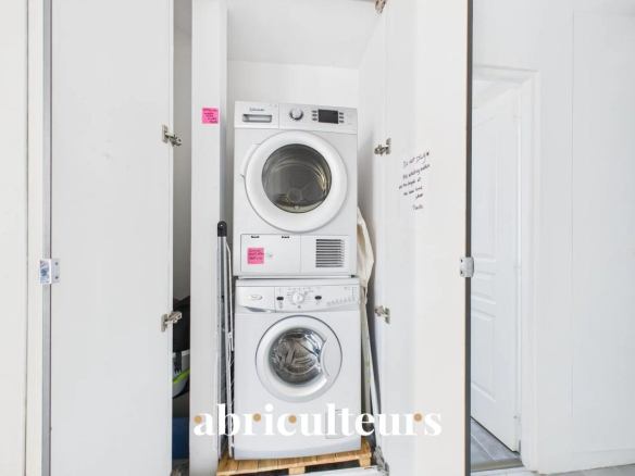 Washing machine and dryer stacked in a storage space.