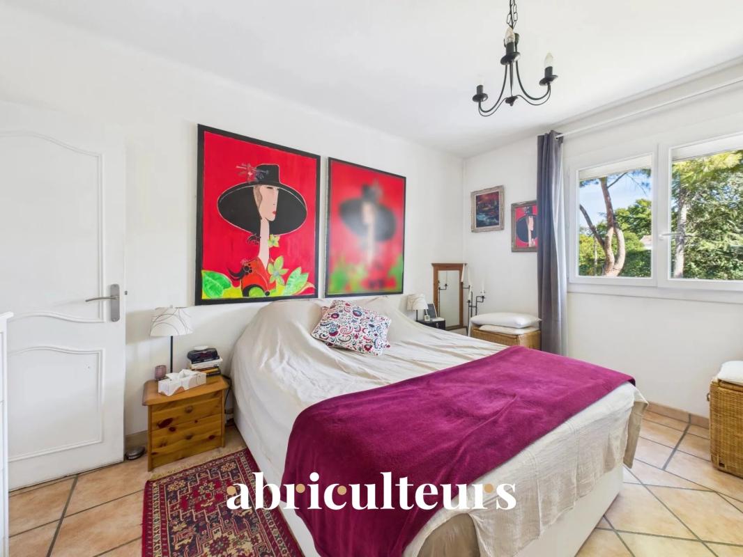 Bedroom in a family home in Bouc-Bel-Air with bed and artistic decoration.