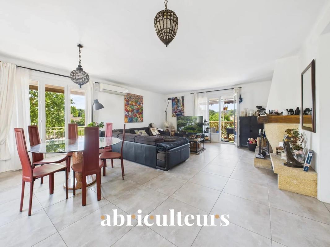 Interior of a spacious family home with living room, dining room and fireplace.