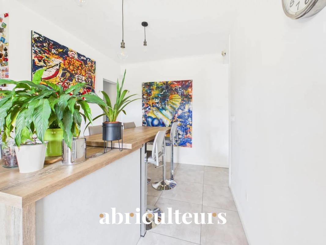 Interior of a family home with a bar and colorful artwork on the walls.