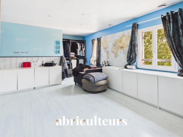 Interior of a spacious villa with modern decor and a view of a wall with a world map.