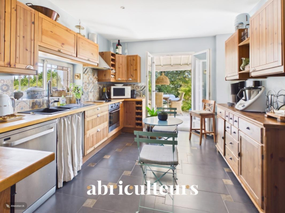 Spacious and bright kitchen in a villa in Callian, with wooden furniture and access to the outside.