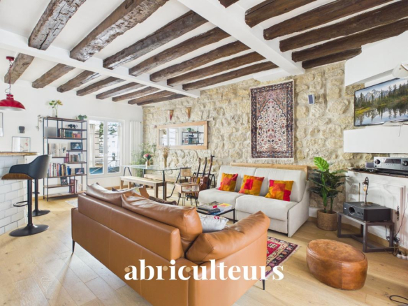 Interior of a two-room apartment with balcony in Paris 11, bright living room with exposed beams.