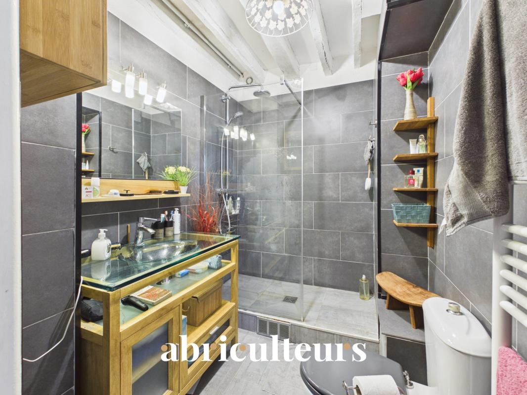 Modern bathroom with walk-in shower and wooden furniture
