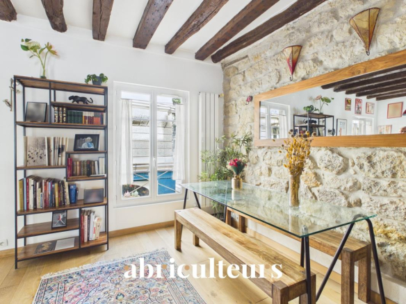 Interior of a two-room apartment with balcony, glass table and shelf, Paris 11.