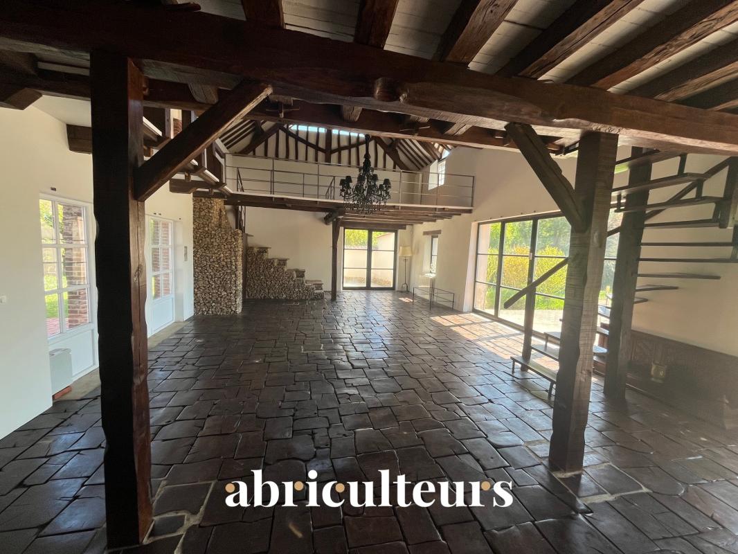 Interior of a renovated house in Croisilles Spacious interior of a renovated house with exposed beams and stone floor.