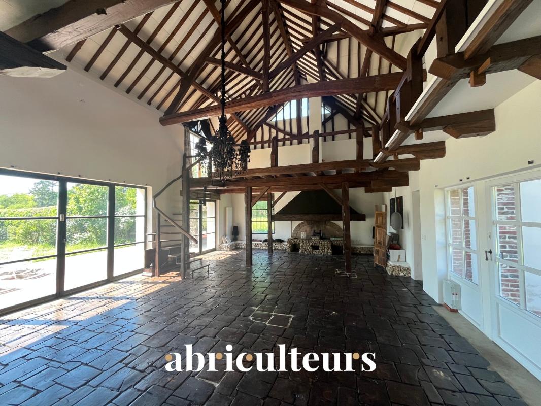 Interior of a renovated 19th-century house Interior of a renovated house with exposed beams and stone floor, bright and open space.