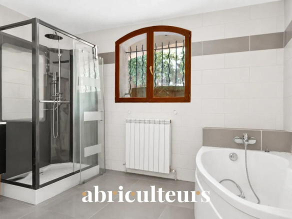 Modern bathroom with shower and bathtub in a family villa.