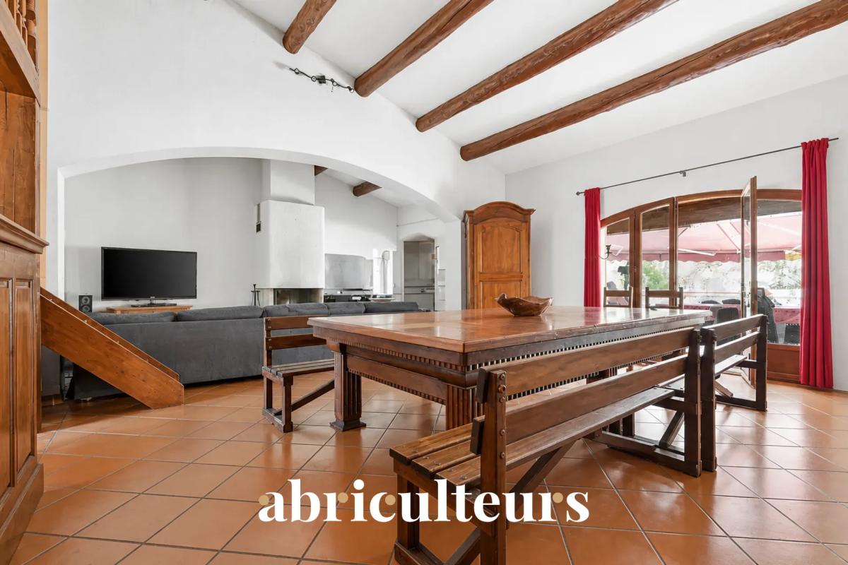 Interior of a family villa in Les Pennes-Mirabeau Interior of a family villa with a wooden table, exposed beams and a sitting area.
