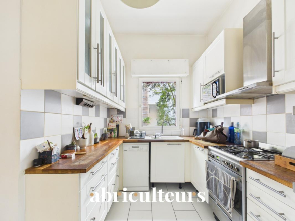 Modern kitchen with wooden worktops and stainless steel appliances.