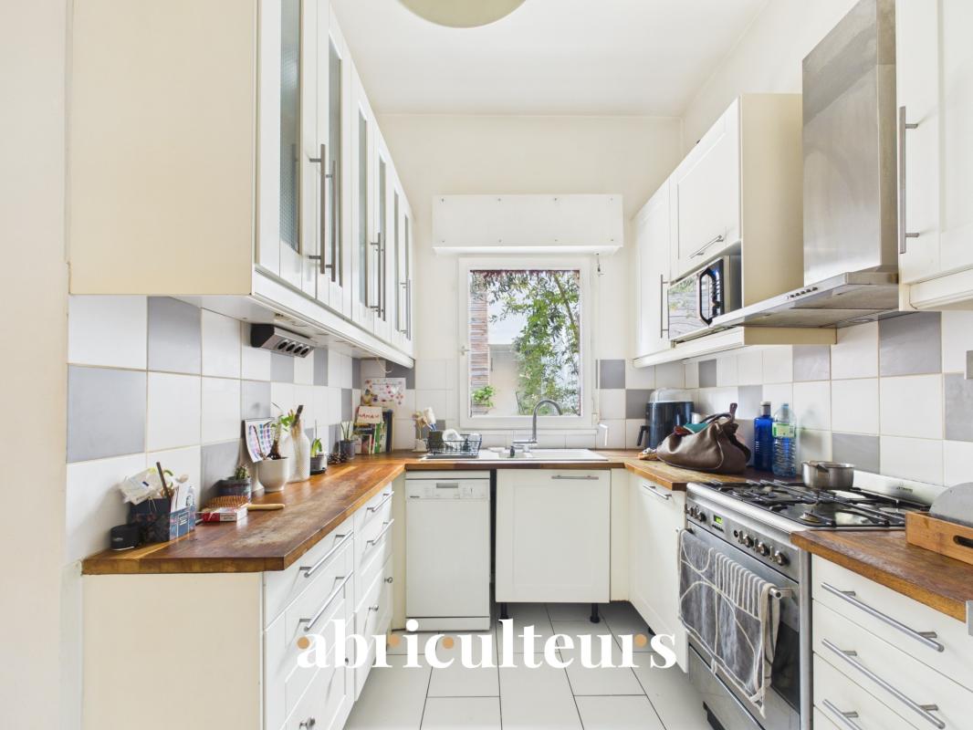 Modern kitchen with wooden worktops and stainless steel appliances.
