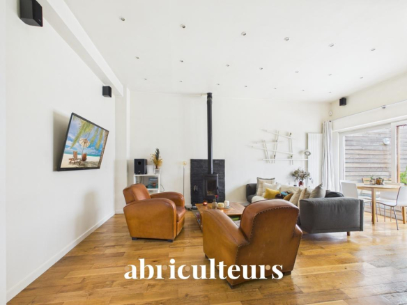 Interior of a duplex in Paris 20th with living room, stove and dining area.