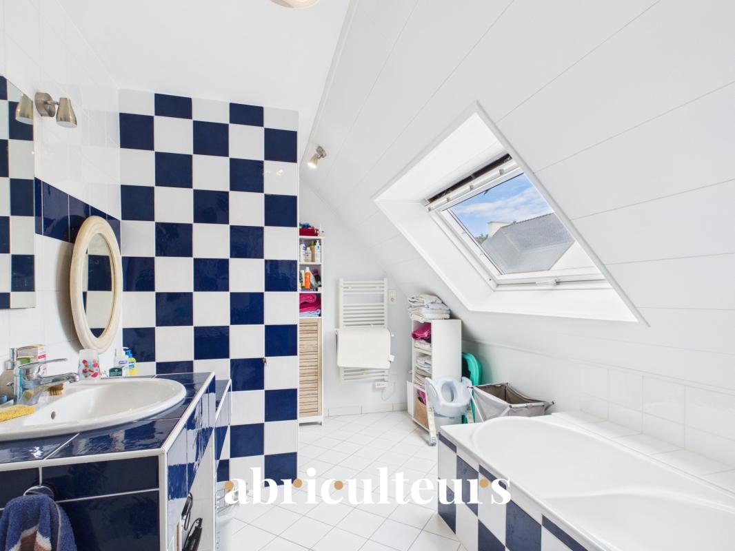 Salle de bains contemporaine Salle de bains moderne avec carrelage à damier bleu et blanc, baignoire et lavabo.