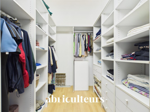 Dressing spacieux avec étagères et penderies dans un appartement rénové.