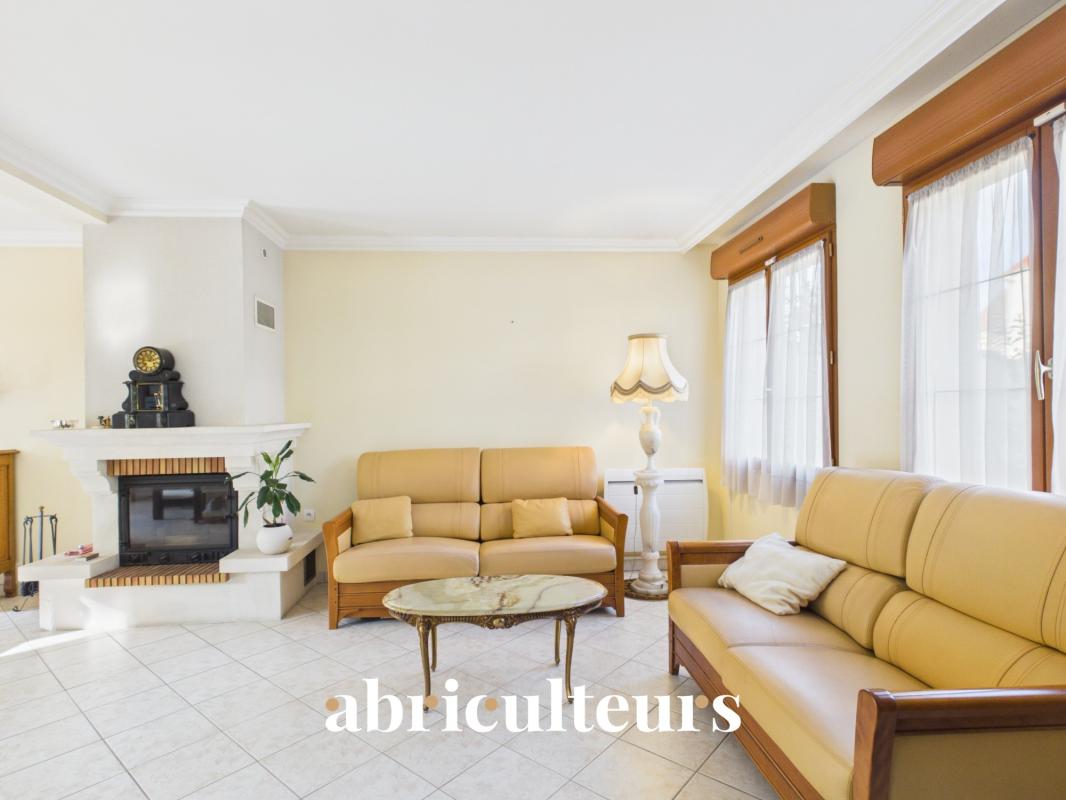 Interior of a house for sale in Versailles Interior of a family home with a large, bright double living room and fireplace.