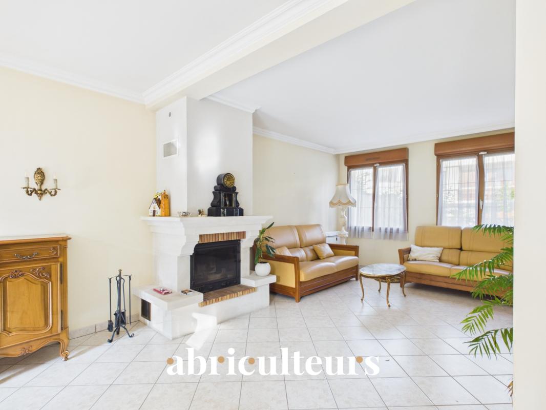 Living room of a house in Versailles Interior of a family home with a bright living room and a fireplace.