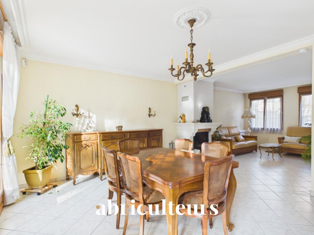 Interior of a house in Versailles Interior of a family home with dining room and fireplace.