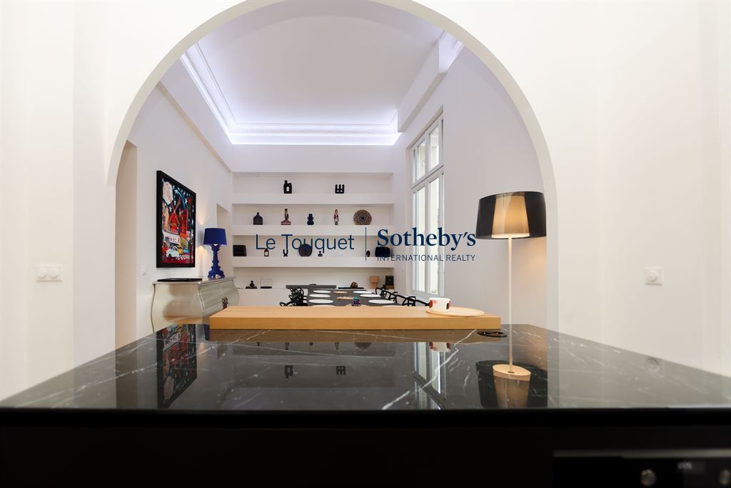 Interior of a contemporary duplex on the ground floor of a former hotel, with high ceilings.