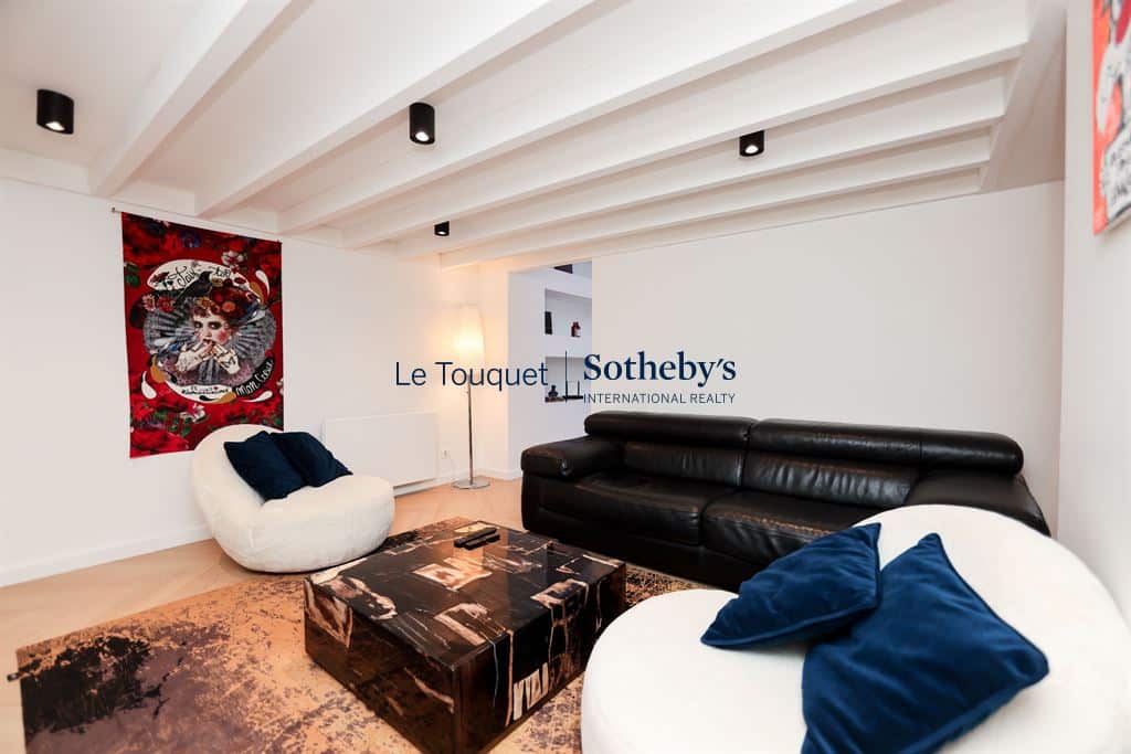 Interior of a contemporary duplex with a modern living room and elegant decorative elements.