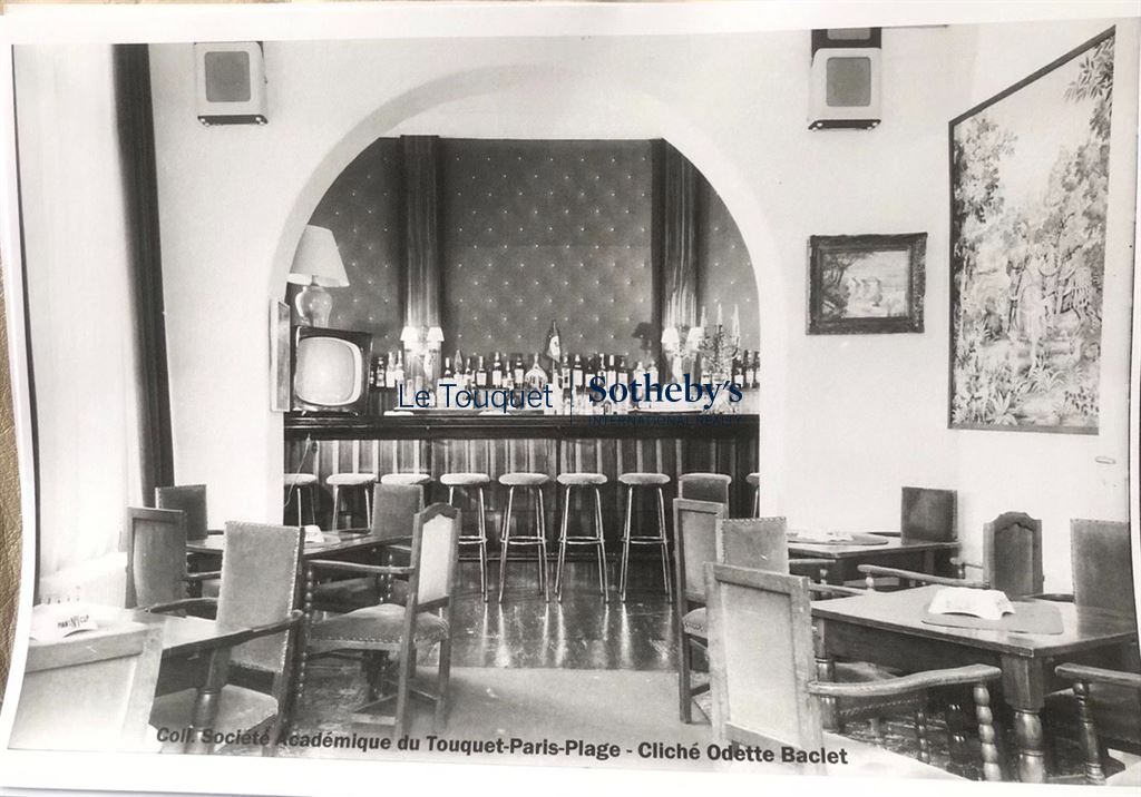 Former restaurant room of a hotel in Le Touquet, decorated with chairs and a bar.