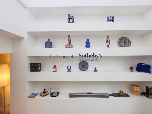 Decorative shelf in a contemporary duplex with art and design objects.