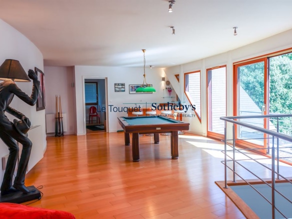Interior of a contemporary villa with living room, billiards and large windows, Le Touquet-Paris-Plage.