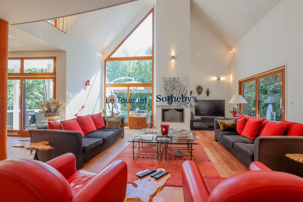Interior of a contemporary villa with spacious living room and large windows, Le Touquet-Paris-Plage.