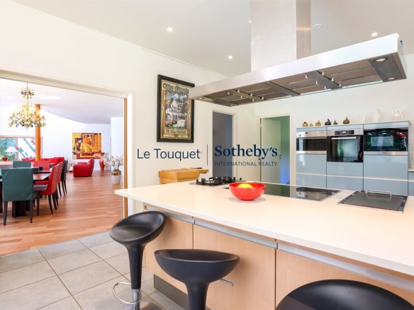 Interior of a contemporary villa with modern kitchen and view of the living room.