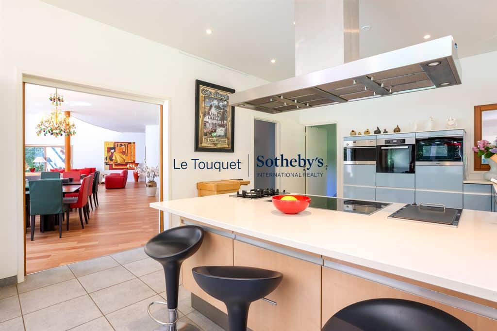 Interior of a contemporary villa with modern kitchen and view of the living room.