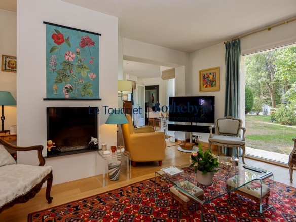 Interior of an elegant family villa with a bright living room and access to a garden.