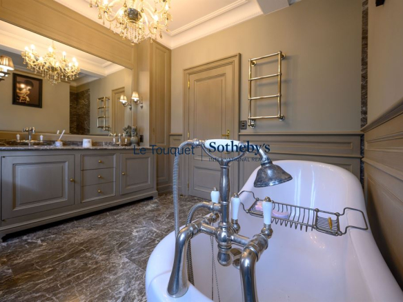 Salle de bain élégante avec baignoire sur pattes et décoration raffinée.