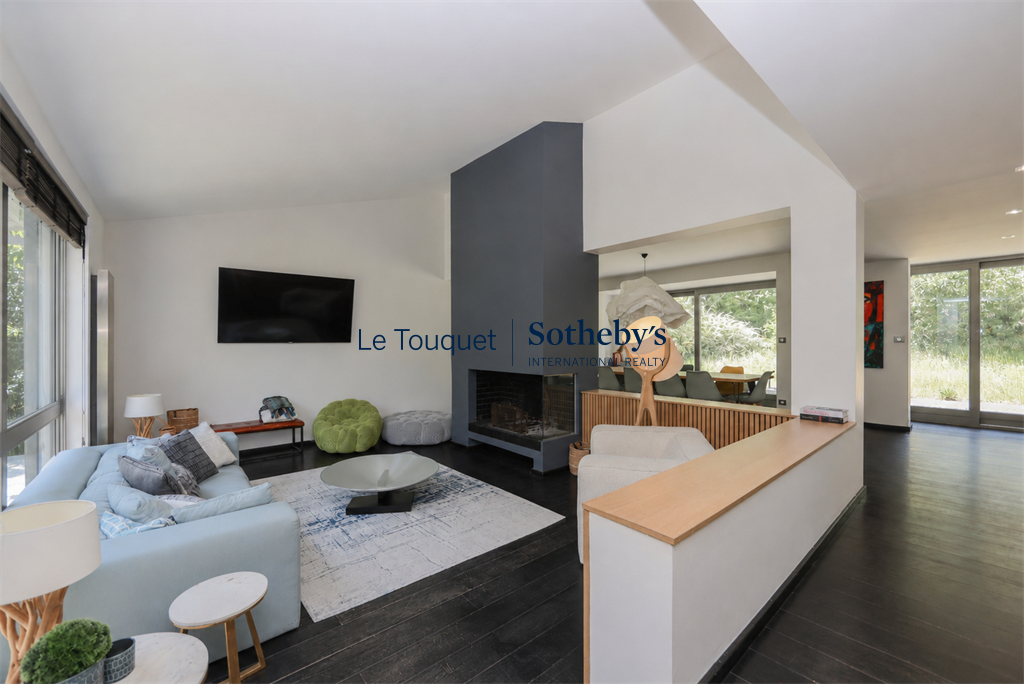 Interior of a contemporary villa Interior of a contemporary villa with living room, fireplace and open space onto the garden.