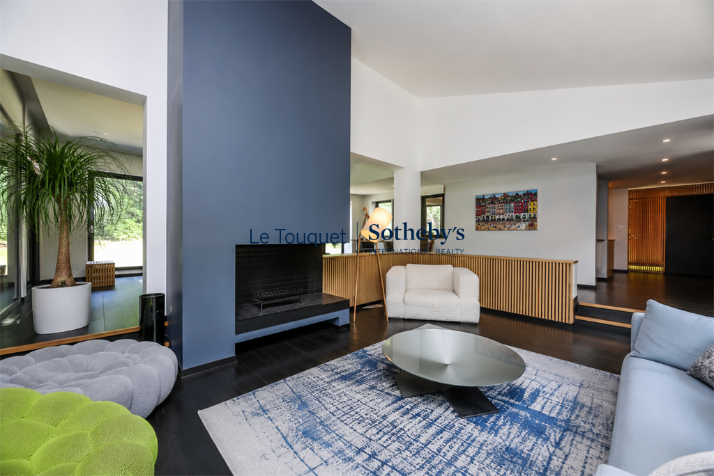 Modern interior of a villa in Le Touquet-Paris-Plage Interior of a contemporary villa with living room and fireplace, modern decor.