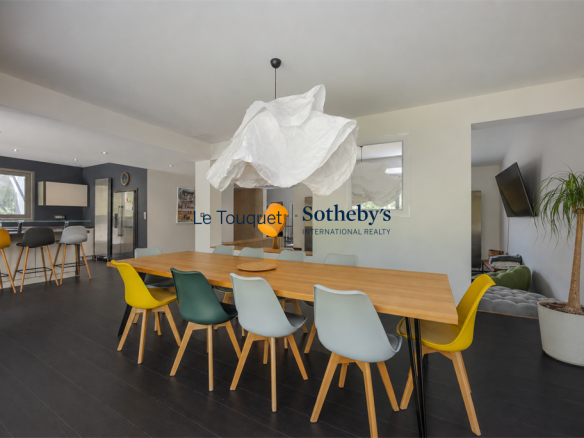 Interior of a contemporary villa with dining room and open kitchen, Le Touquet-Paris-Plage.